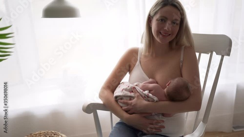 A Mother breastfeeding her little baby girl in her arms.