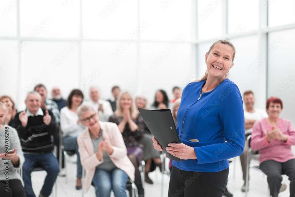 Businesswoman addressing colleagues at office meeting Businesswoman addressing colleagues at office meeting