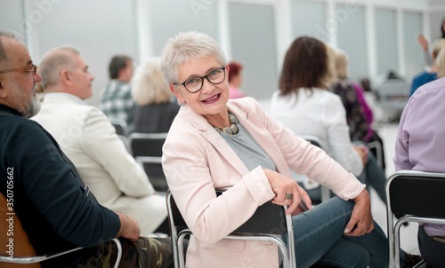 Woman at presentation looks at camera