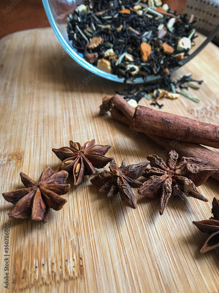 tea with pieces of fruits and cinnamon on wooden desk tea with pieces of fruits and cinnamon on wooden desk