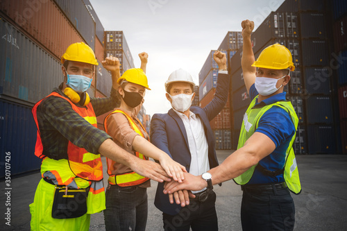 Handshake among businessmen, engineers, chief technicians and foreman, concept of cooperation in working on cantainer yard warehouses and international transportation. photo