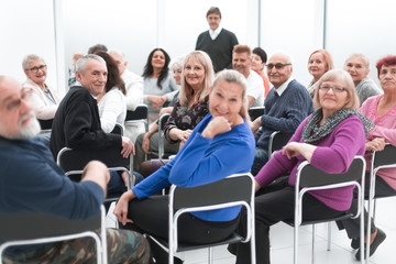 Adult people listen to the motivational speech of the lecturer