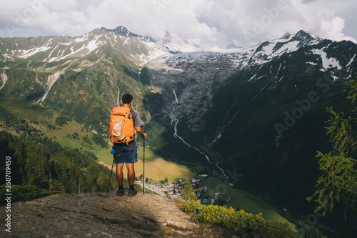 Man hiker standing on a hilltop in the French Alps, Le Tour, France photo