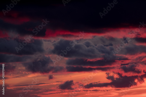 large dark clouds at sunset in spring
