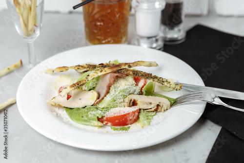 Fresh caesar salad with chicken breast and tomatoes