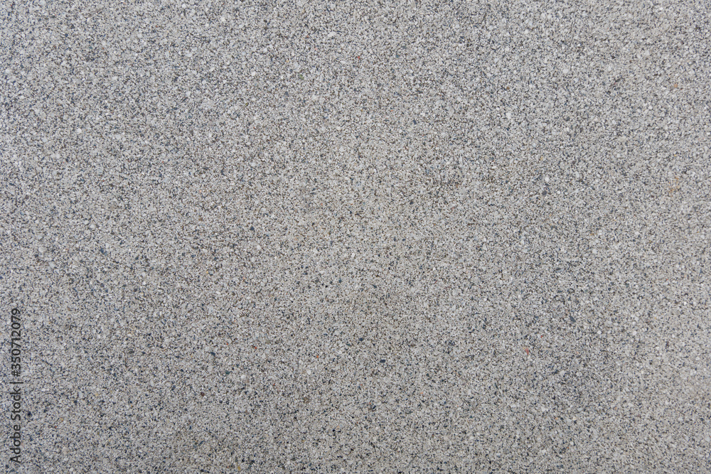 Close up small tiny stone pebble in concrete floor texture background Close up small tiny stone pebble in concrete floor texture background