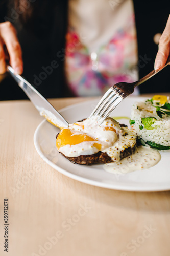 poached egg on steak with rice garnish
