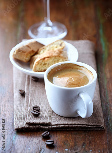  Cup of coffee with cantuccini (Italian cookies) on rustic wooden background.