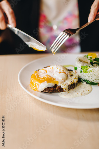 poached egg on steak with rice side dish