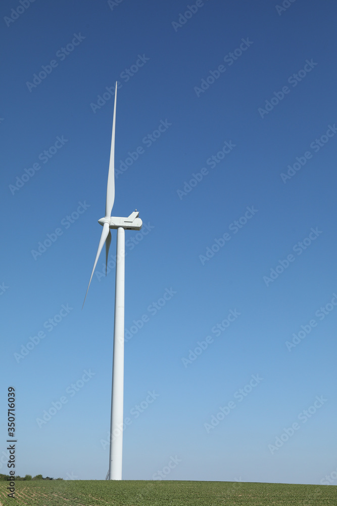 Windmill for electric power production, France. Blue sky Windmill for electric power production, France. Blue sky