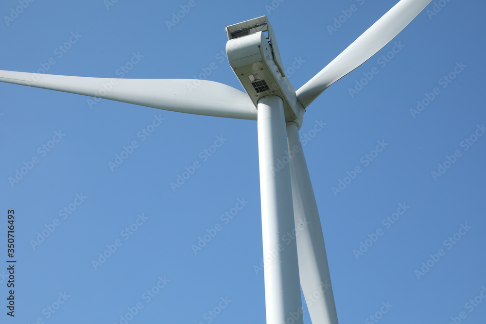 Windmill for electric power production, France. Blue sky Windmill for electric power production, France. Blue sky