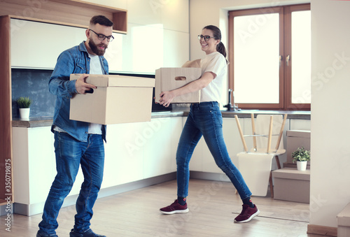 Couple holding boxes for moving the hands and have a dance with boxes