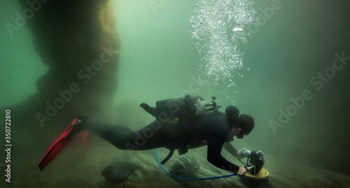 Photography Proffesional diver clean a tank on the Aquarium.