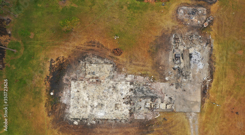 Forest wildfire in the forest with some burned trees and houses. Ashes from wood and houses