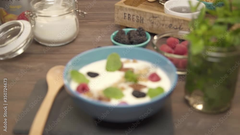 Blue bowl of berries and mint leaves on smoothie - rack focus.mp4 Blue bowl of berries and mint leaves on smoothie - rack focus.mp4