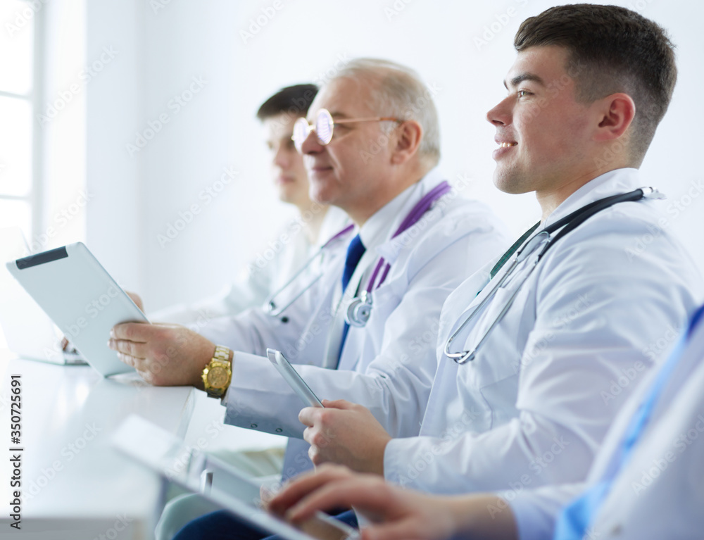 Medical team sitting and discussing at table Medical team sitting and discussing at table