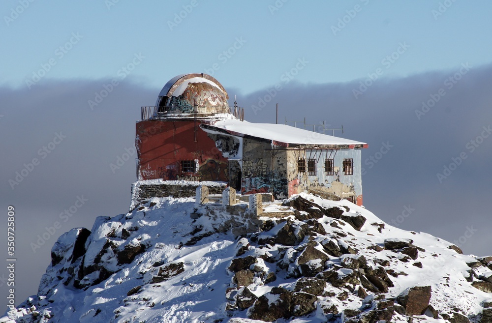 Abandoned snow-covered observatory on the mountain Sierra Nevada of Spain. Winter time