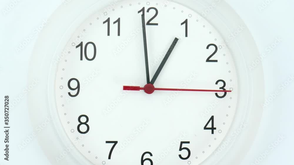 Close up White wall clock isolated on white background, face beginning of time 01.00 am or pm, Clock minute walk slowly, Time concept. Close up White wall clock isolated on white background, face beginning of time 01.00 am or pm, Clock minute walk slowly, Time concept.