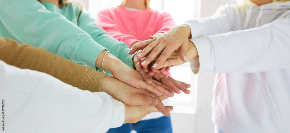 Group of teens stacking their hands, unity and solidarity Group of teens stacking their hands, unity and solidarity