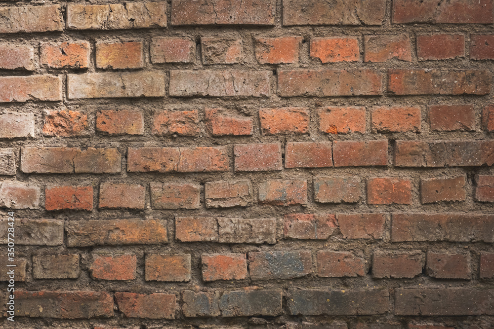 Weathered texture of stained old dark brown and red brick wall background, grungy rusty blocks of stone-work technology, colorful horizontal architecture Weathered texture of stained old dark brown and red brick wall background, grungy rusty blocks of stone-work technology, colorful horizontal architecture
