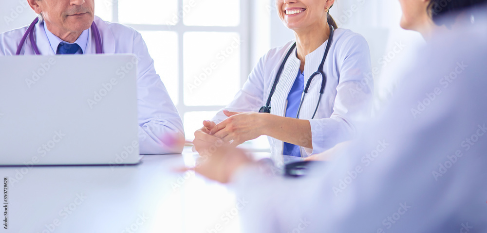 Serious medical team discussing patient's case in a bright office
