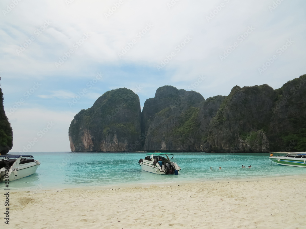 Obraz premium Maya Bay - Beautiful beach in Phi Phi Island, Famous landmark travel Phuket Thailand beach. Tourism destination Asia trips. Nobody. It's a nasty day. Moored boats