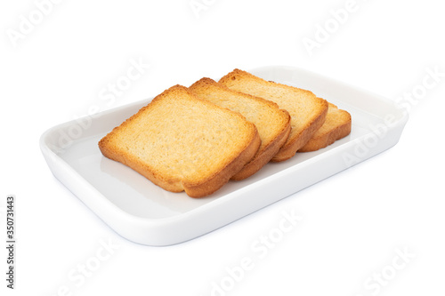 Horizontal crispy biscottes, square cracker on white plate, on white background (Tr- etimek)