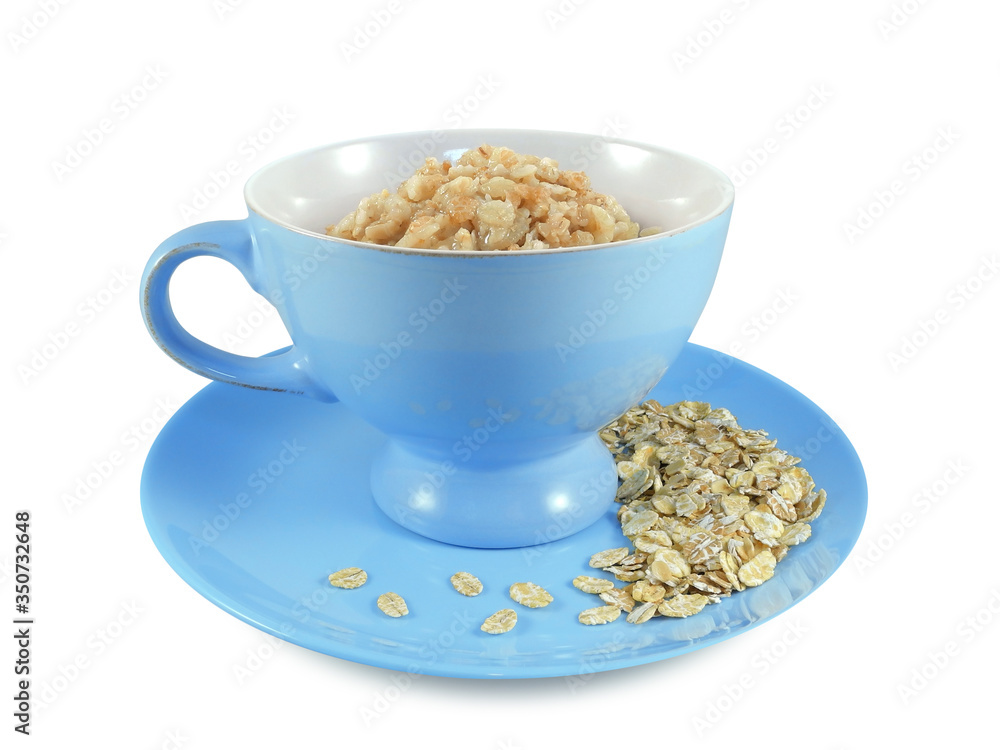 Oatmeal in blue bowl on plate with sprinkled dry oat flakes isolated on white background Oatmeal in blue bowl on plate with sprinkled dry oat flakes isolated on white background