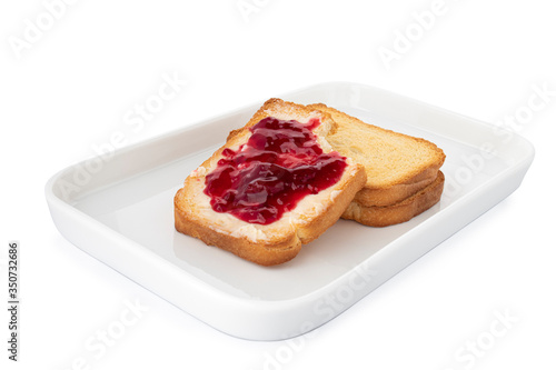 Bitten crispy biscotti with butter and jam, square cracker on white plate, on white background (Tr- recelli etimek)