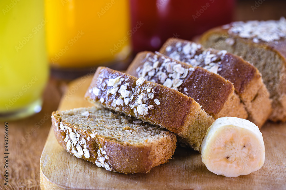 Sliced ​​vegan bread, gluten-free and without animal products. Vegetarian bread with oatmeal, banana flavor, on a rustic white table, sliced ​​and ready to serve.