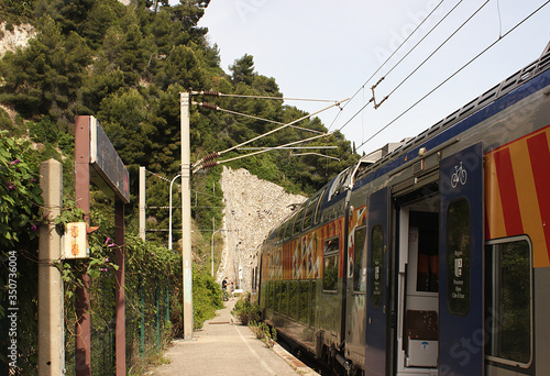 Train arriving at the station. Train station Villefranche-sur-Mer. A city on the French Riviera. Region Provence-Alpes-Cote d'Azur.