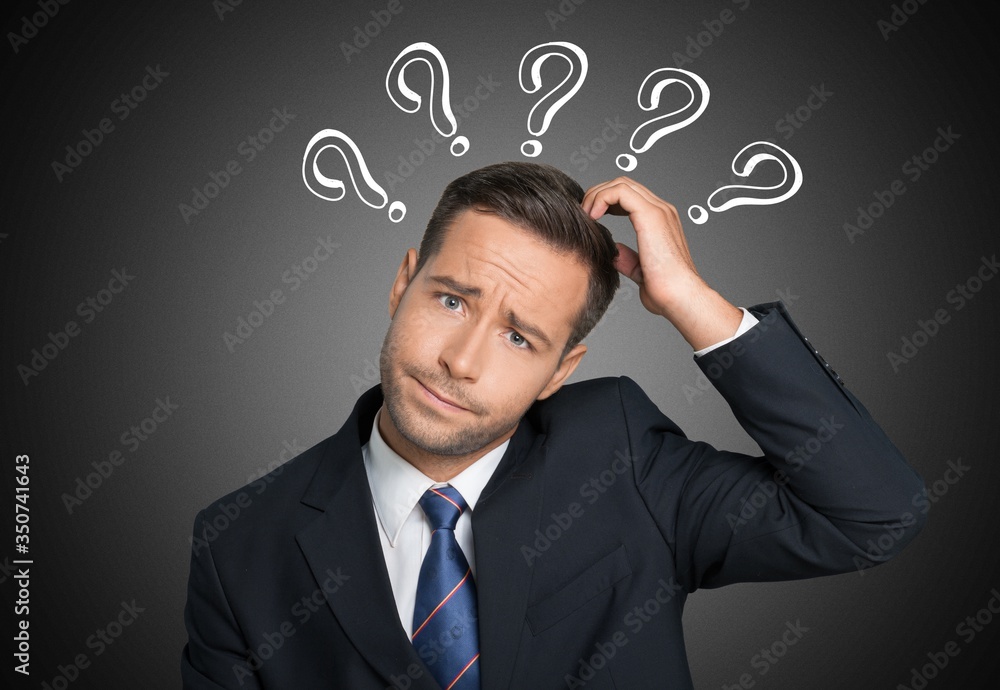 Young businessman scratching his head, hard decision Young businessman scratching his head, hard decision
