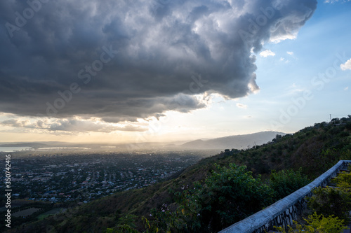 dark storm clouds roll and loom over a city during a cool sunset one spring afternoon 