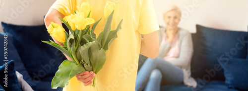 Boy holding flowers for his mother. photo