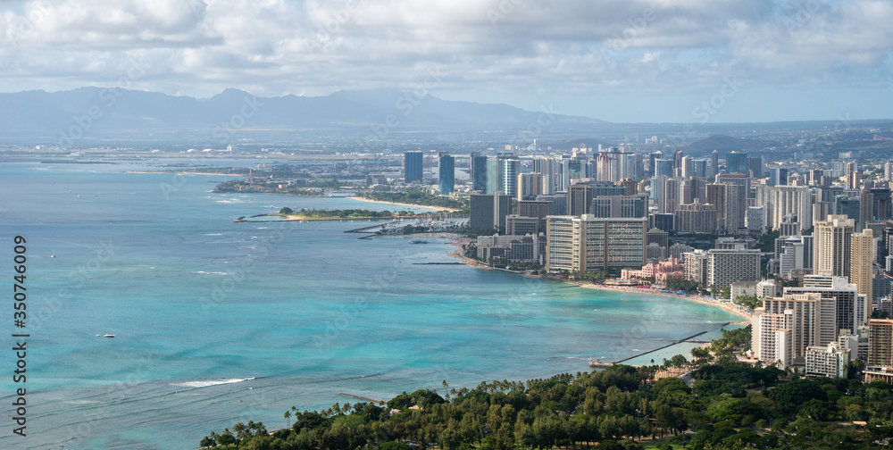 Vista on coastal city with azure waters, shot at Diamond Head Lookout near Honolulu, Hawaii, USA