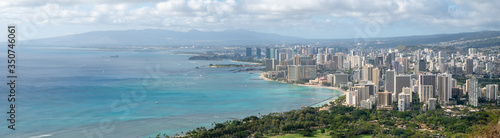 Very wide panoramic shot of coastal city with azure waters, shot at Diamond Head Lookout near Honolulu, Hawaii, USA