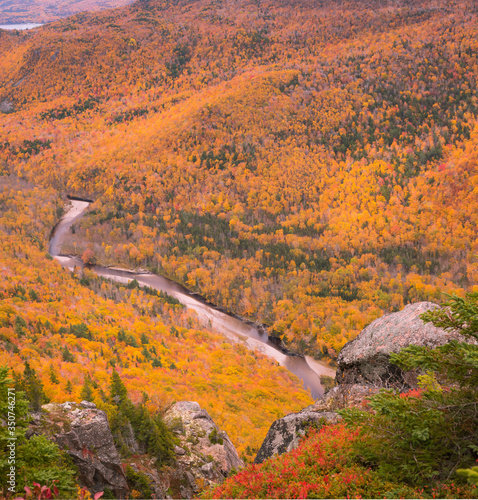 French Mountain valley in Cape Breton Nova Scotia during Autumn. Fall foliage of the mountains with multi colored deciduous trees, Cabot Trail 
