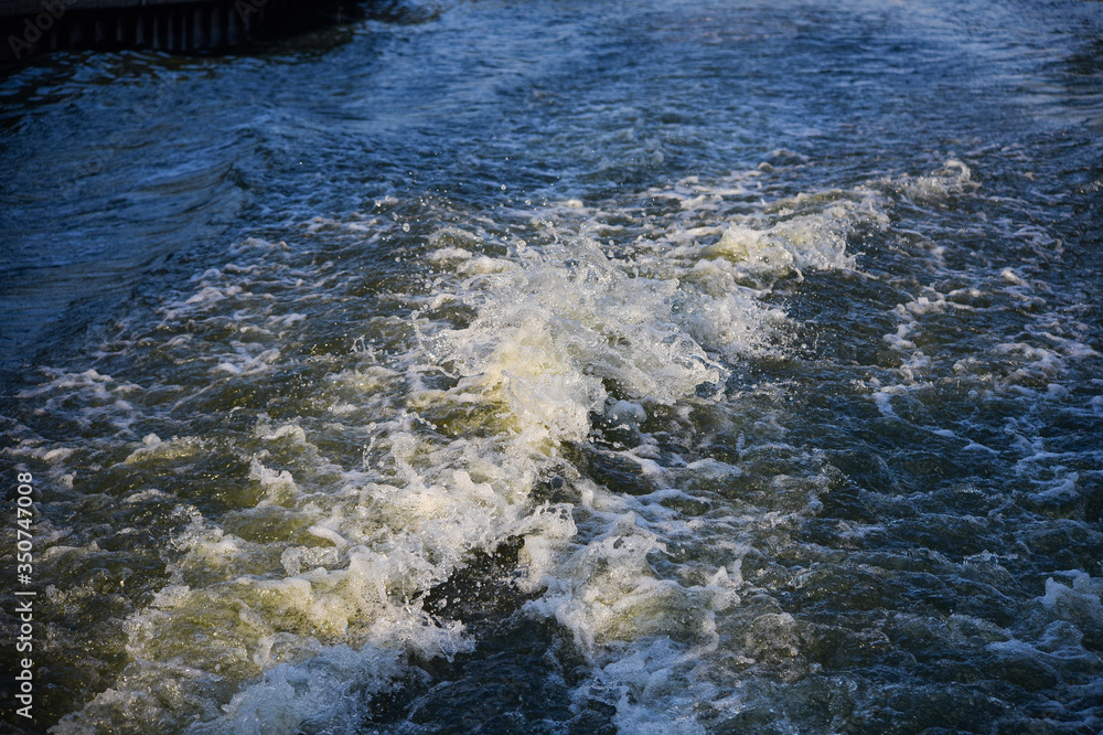 Trail on water surface behind of fast moving motor boat Trail on water surface behind of fast moving motor boat