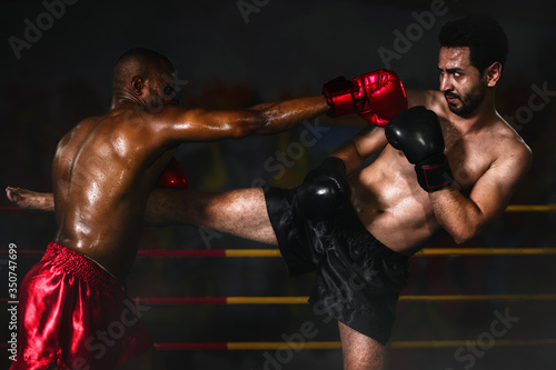 african american boxer making yap punch in defencing to caucasian boxer making yap in muay thai or kickboxing fighting mactch © Mongkolchon