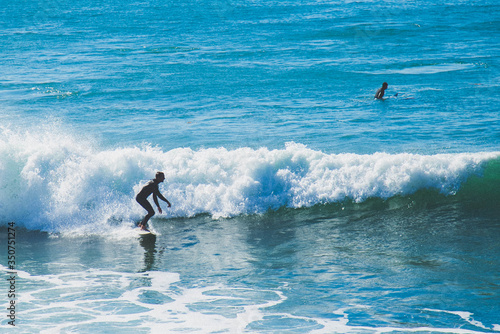 Photography Surfer in action in Laguna beach in southern California in January heisler park