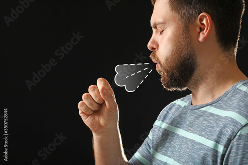 Coughing man on dark backgr...