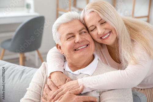 Happy elderly couple resting at home