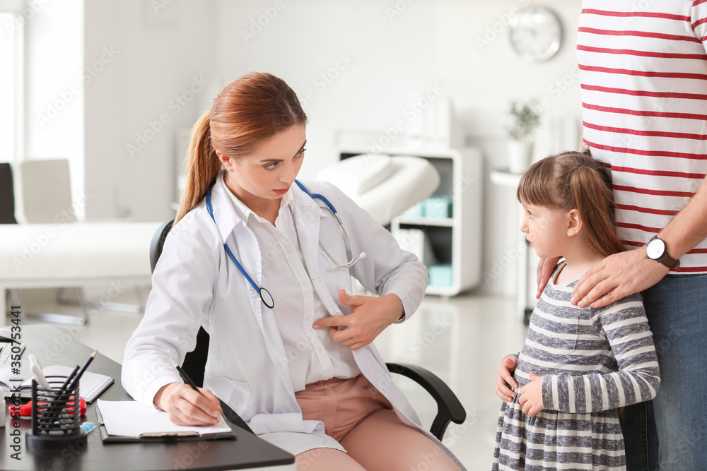 Man with his little daughter visiting gastroenterologist in clinic Man with his little daughter visiting gastroenterologist in clinic