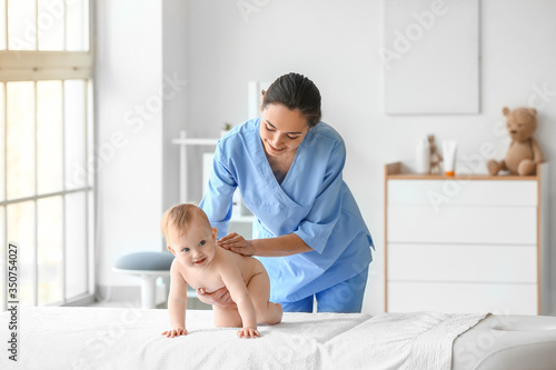 Massage therapist working w...