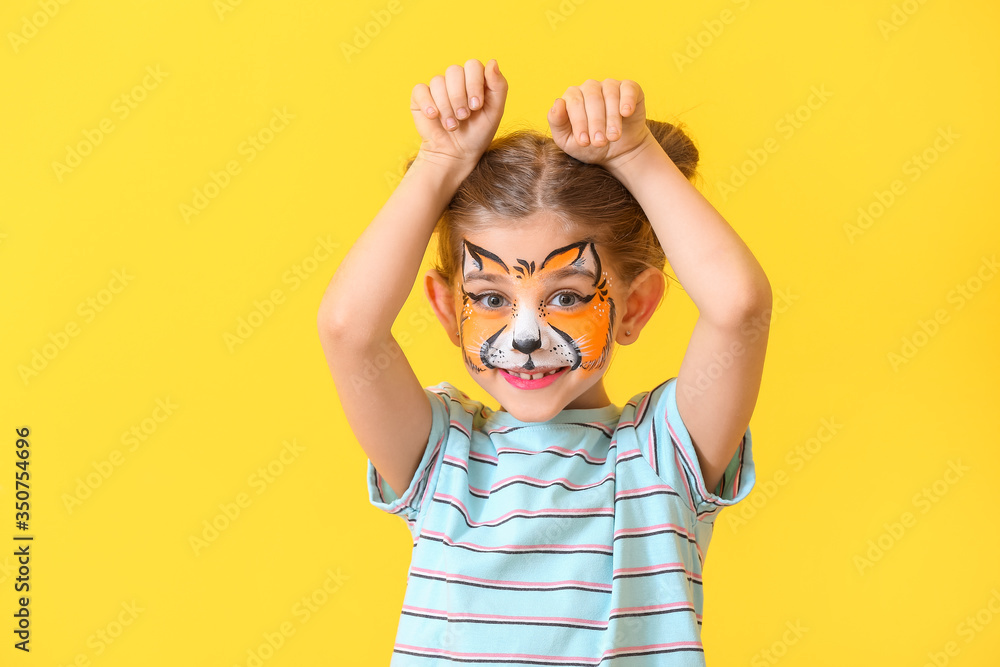 Funny little girl with face painting on color background Stock Photo ...