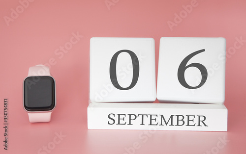 Modern Watch with cube calendar and date 06 september on pink background. Concept autumn time vacation.