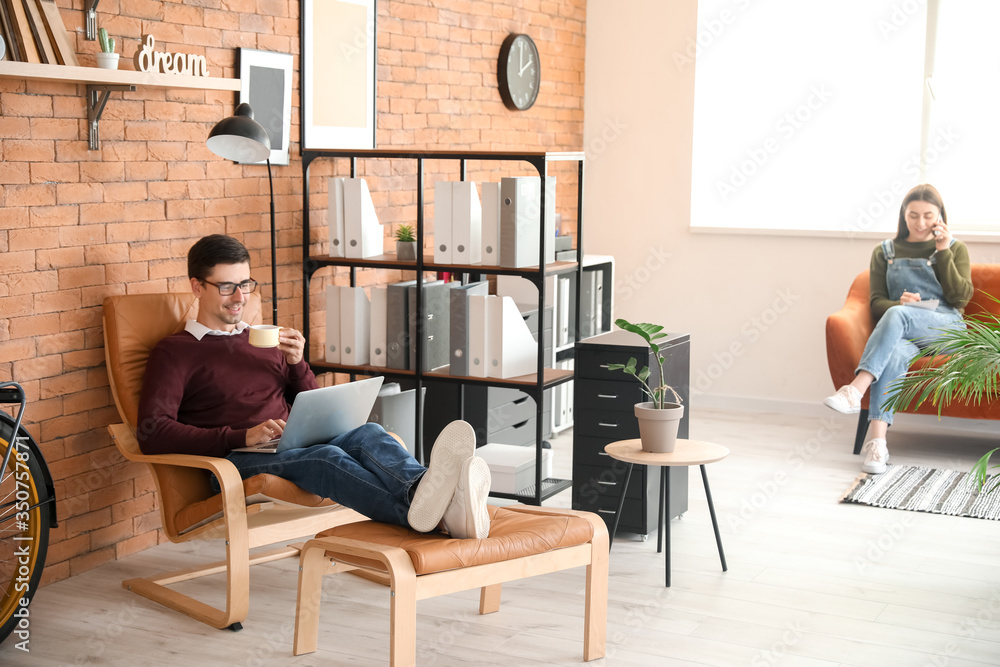 Young man with wife working together at home