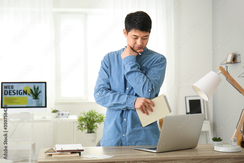 Young Asian man working at home