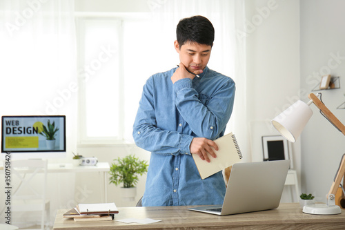 Young Asian man working at home
