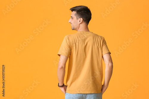Man in stylish t-shirt on c...